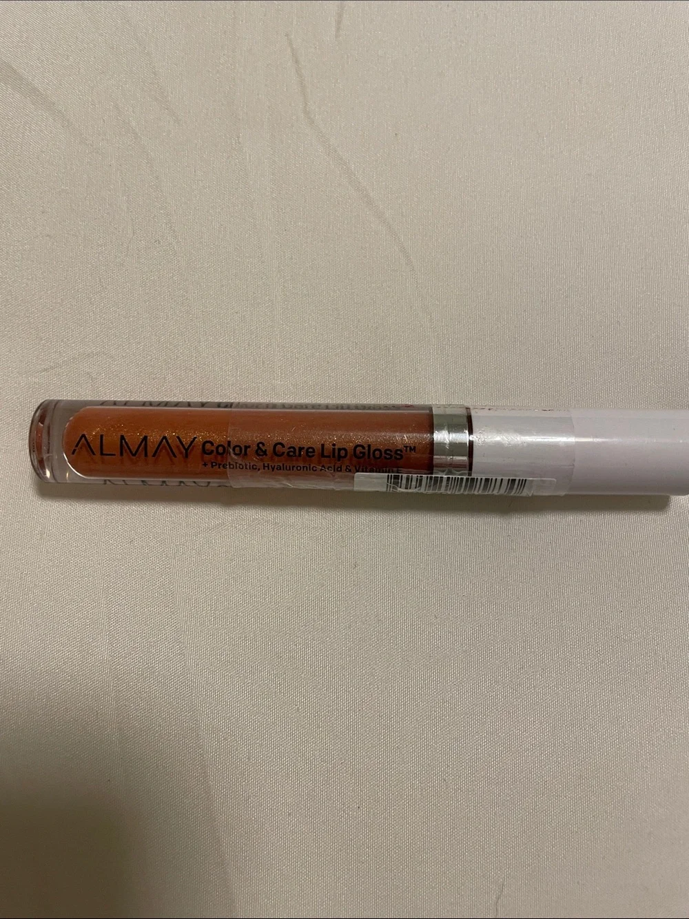 Almay Shimmering Peach-Coral Color & Care Lip Gloss